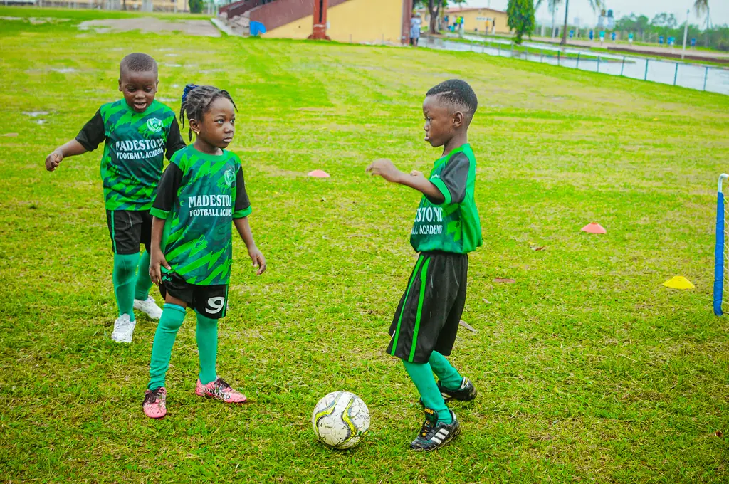 Two of the youngest Madestone players with a ball on the grass