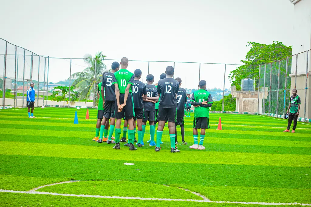Madestone players gathered in a huddle on the pitch